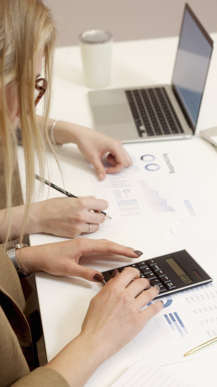 about-img Team working with a calculator and reports on a professional desk.